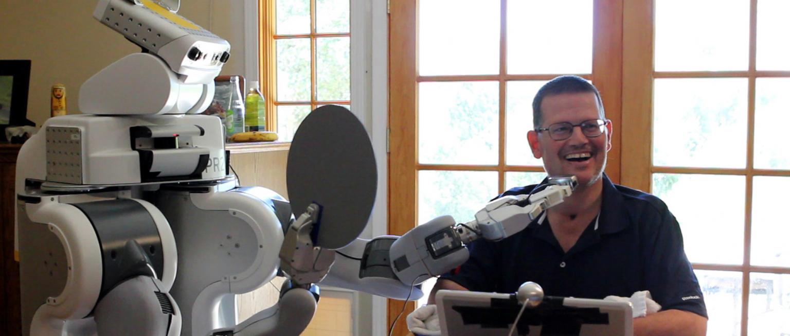 Manipulator robot shaves a man's face