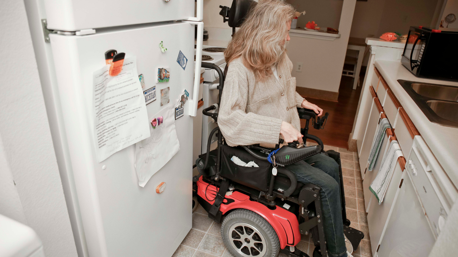 female wheelchair user in the kitchen.