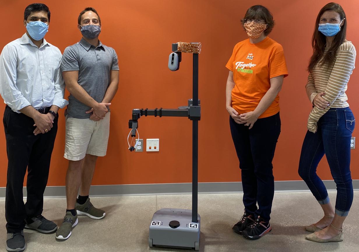 four researchers standing by Stretch Robot