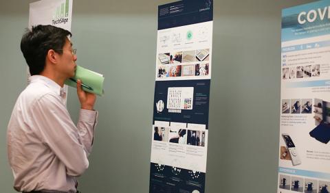 Man looking at design competition posters
