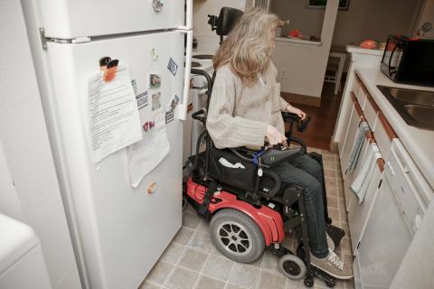 female using wheelchair in kitchen