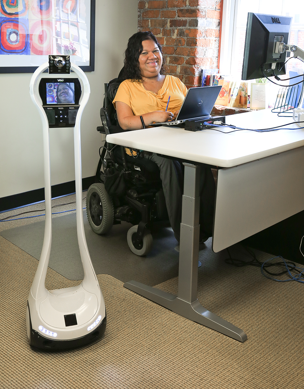 A mobile robot being used by a woman in a wheelchair